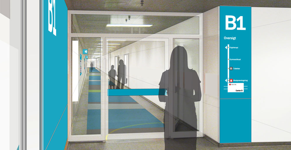 Directional and locational signage placed in hallway at Hvidovre Hospital
